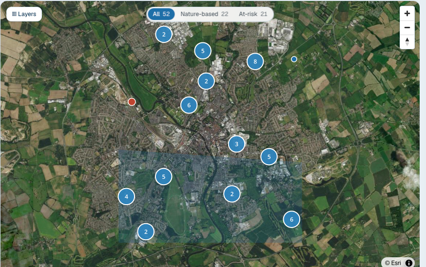 An interactive satellite map of the authority catchment, with flood assets shown as clustered numbered markers coloured by change signal, and a selected zone highlighted.